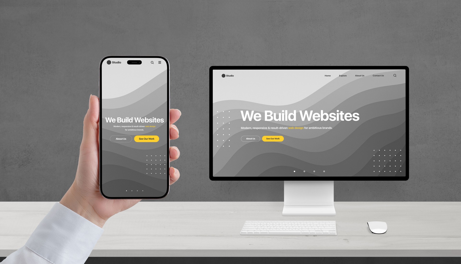 Responsive web design concept on phone and computer, studio portfolio page with 'We build websites' headline